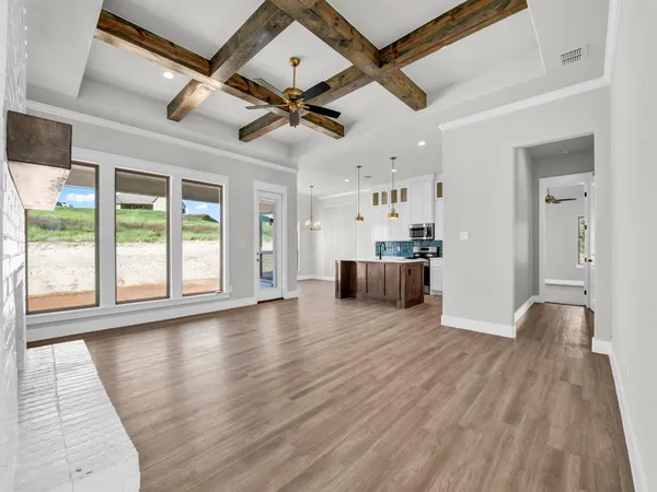 a view of a livingroom with hardwood floor and a ceiling fan