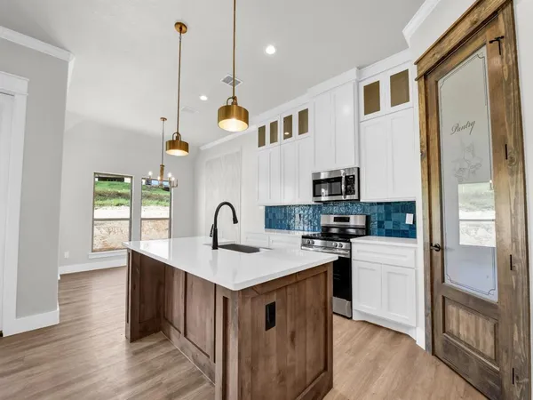 a kitchen with a sink stove and refrigerator