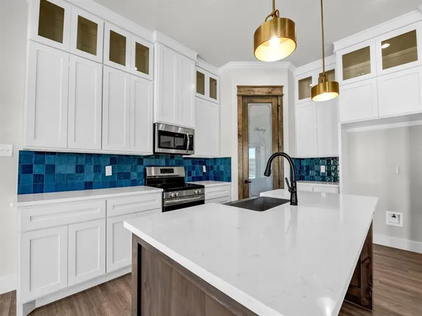 a kitchen with cabinets and window