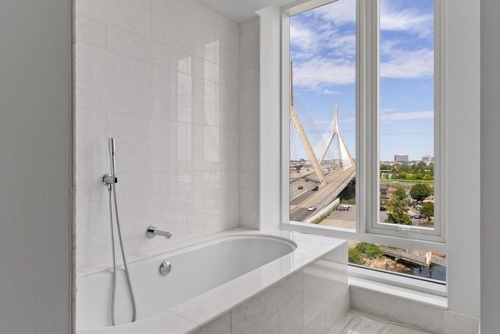 100 Lovejoy Wharf, Unit 14D Boston, MA 02114 - Photo 12 of 34 a bathroom with a bathtub and a window