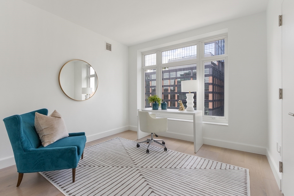 100 Lovejoy Wharf, Unit 14D Boston, MA 02114 - Photo 19 of 34 a room with furniture and a window