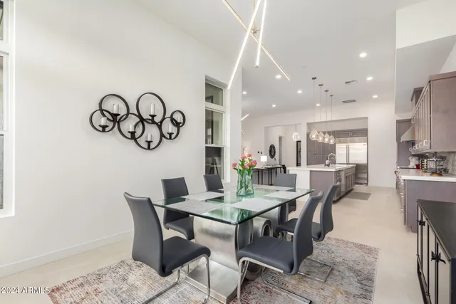 a bedroom with a large bed and a potted plant