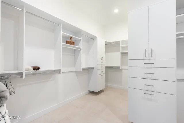 a bedroom with a bed and painting on the wall