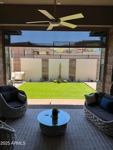 a view of a patio with table and chairs and potted plants