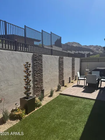 a view of a house with a yard and sitting area