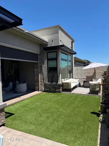 a living room with furniture and a floor to ceiling window