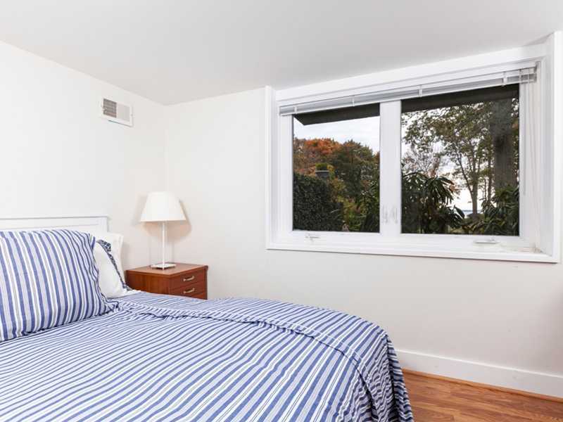 37 Contentment Island Road Darien, CT 06820 - Photo 17 of 24 a bedroom with a bed and a large window