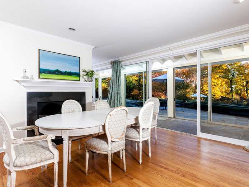 37 Contentment Island Road Darien, CT 06820 - Photo 6 of 24 a dining room with furniture a fireplace and wooden floor