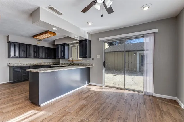a large kitchen with stainless steel appliances granite countertop a stove and a sink