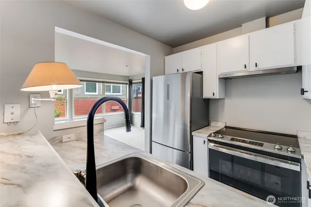 a kitchen with stainless steel appliances a stove and a refrigerator