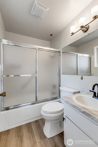 a bathroom with a toilet a sink and shower