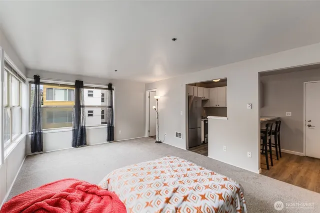 a bedroom with a large bed and a chandelier