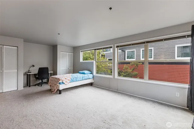 a living room with furniture and large windows