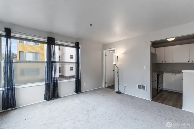 a view of a kitchen with a refrigerator and a sink
