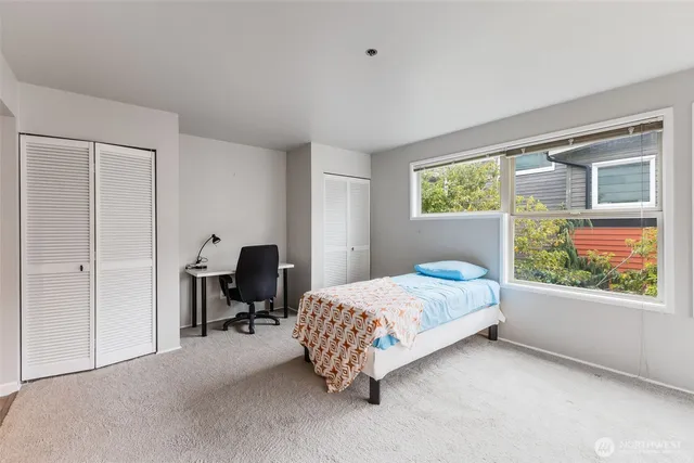 a bed room with a bed and a window