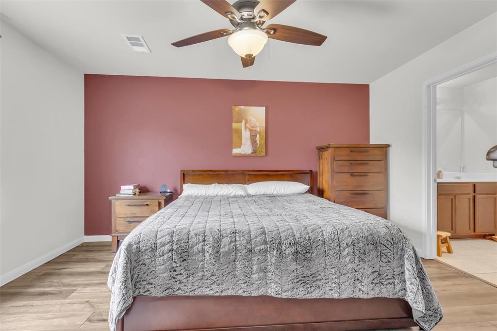 1911 Pilot Point Way Princeton, TX 75407 - Photo 15 of 23 a bedroom with a bed and a chandelier