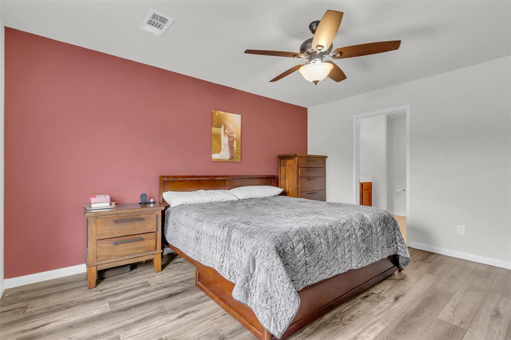 1911 Pilot Point Way Princeton, TX 75407 - Photo 16 of 23 a bedroom with a bed and a chandelier