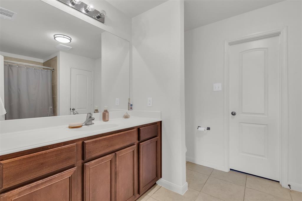 1911 Pilot Point Way Princeton, TX 75407 - Photo 17 of 23 a bathroom with a sink and a mirror