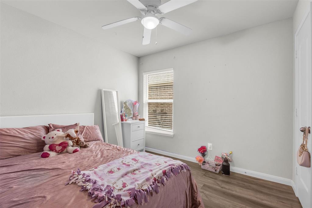 1911 Pilot Point Way Princeton, TX 75407 - Photo 19 of 23 a bedroom with a bed and a window