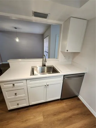 a kitchen with a sink and cabinets
