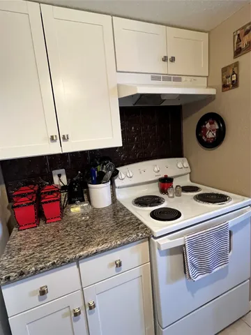 a kitchen with a stove and a microwave