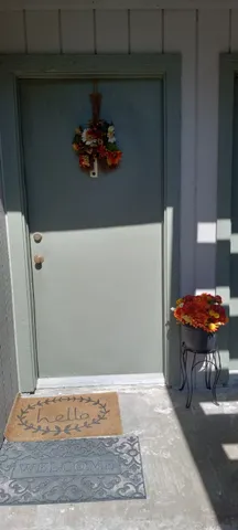a backyard of a house with table and chairs