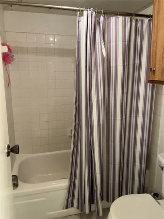 a bathroom with a shower curtain and a sink