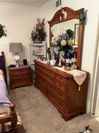 a bedroom with a bed and a painting on the wall