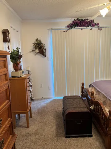 a bedroom with a bed and a potted plant