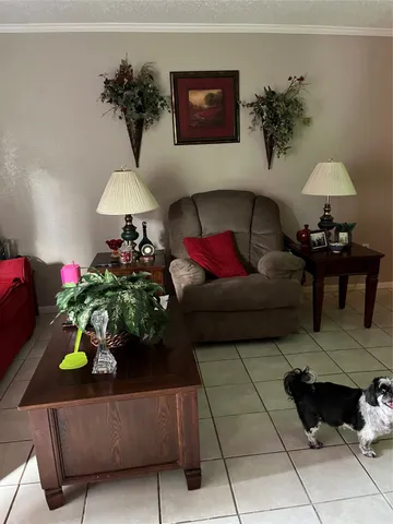 a living room with furniture and flowers