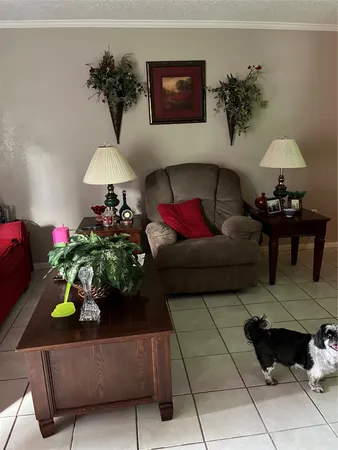 a living room with furniture and flowers