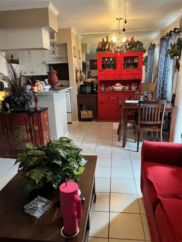 a kitchen with a refrigerator and a potted plant