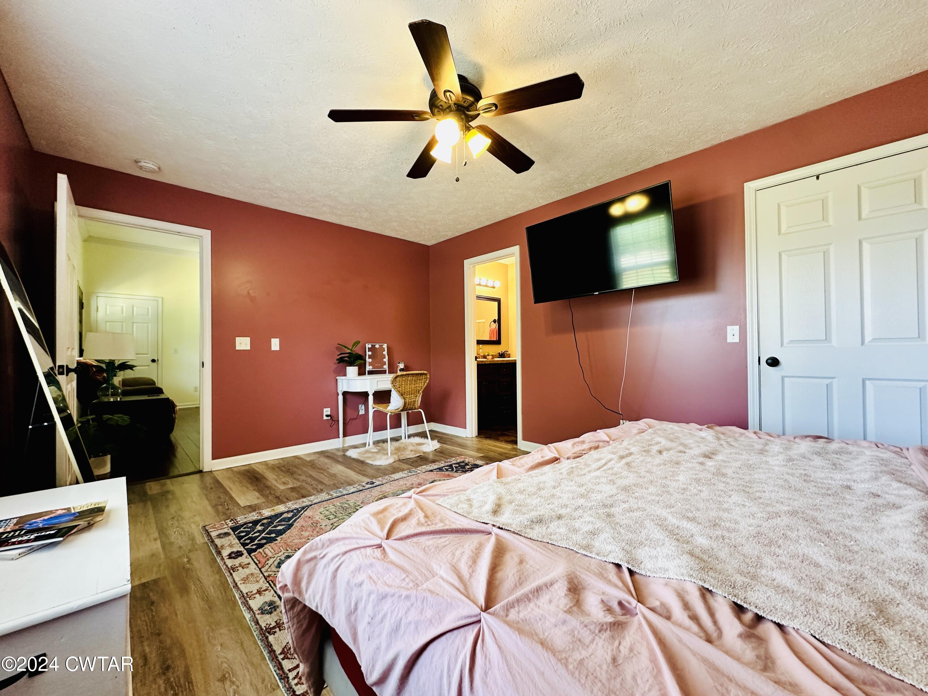 5295 Sunshine Road Henderson, TN 38340 - Photo 20 of 30 a bedroom with a bed and a flat screen tv