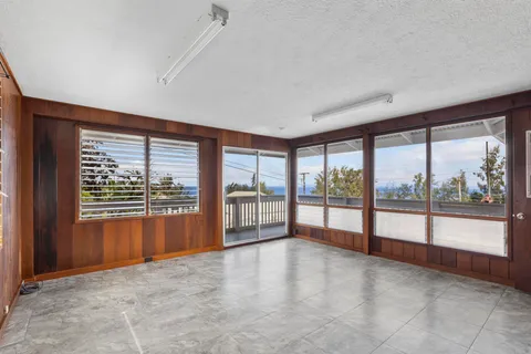 wooden floor in an empty room with a large window