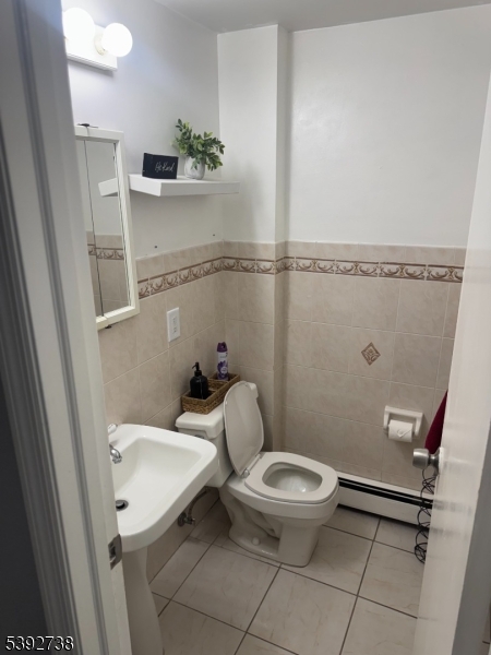 828 Allen Street Linden, NJ 07036 - Photo 14 of 17 a bathroom with a toilet a sink and a mirror