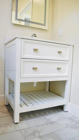 a bathroom with a sink a mirror and a bathtub