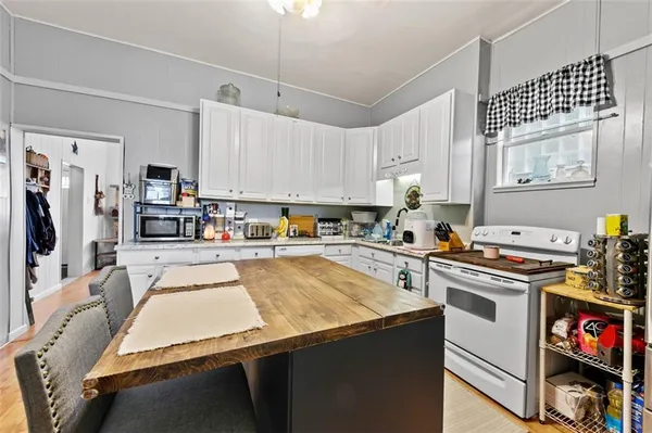 a kitchen with stainless steel appliances granite countertop a stove refrigerator sink and cabinets