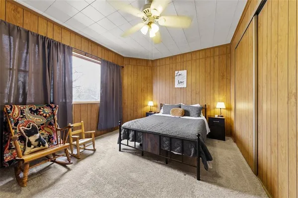 a bedroom with a bed and a chandelier