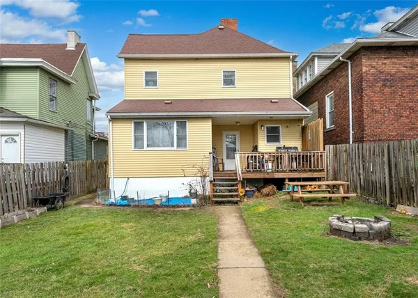 a front view of a house with a yard table and chairs