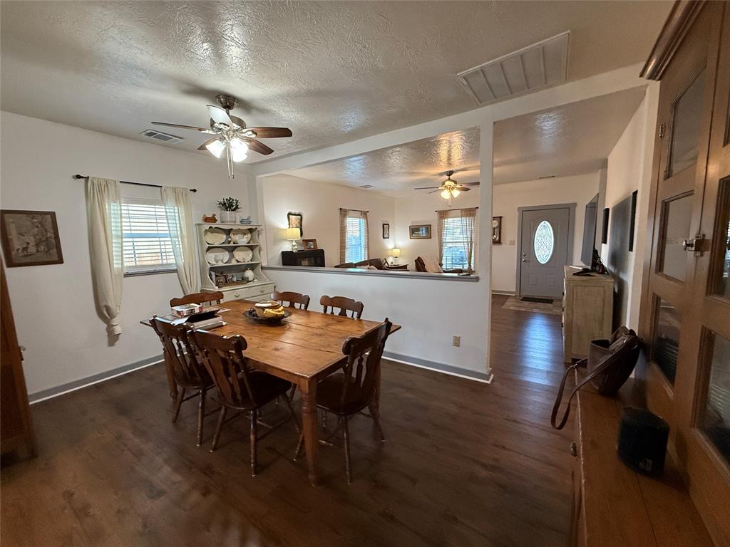407 South Reagan Street Hamilton, TX 76531 - Photo 12 of 39 a view of a dining room with furniture and wooden floor