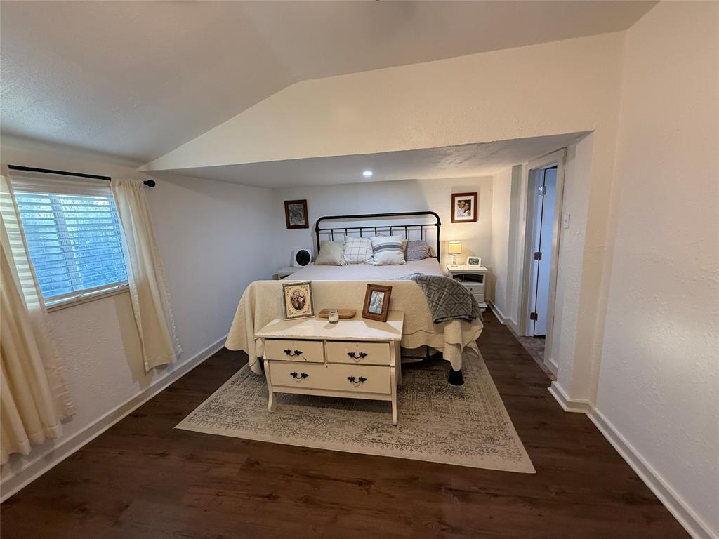 407 South Reagan Street Hamilton, TX 76531 - Photo 21 of 39 a white bed sitting in a bedroom next to a window