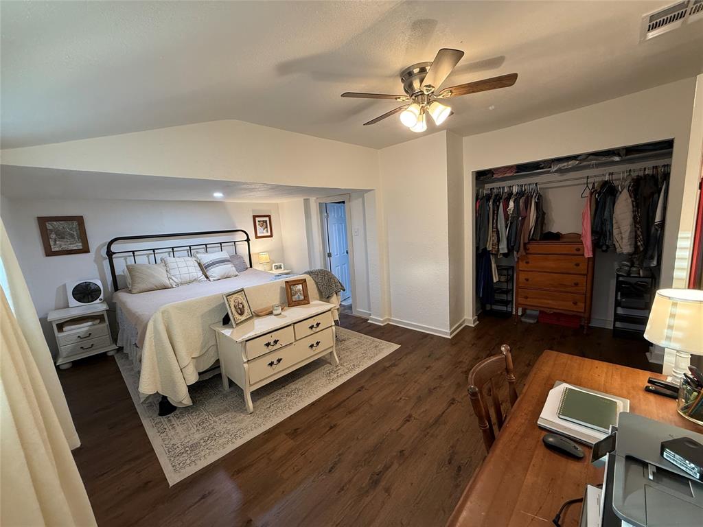 407 South Reagan Street Hamilton, TX 76531 - Photo 22 of 39 a bedroom with a bed and a chandelier