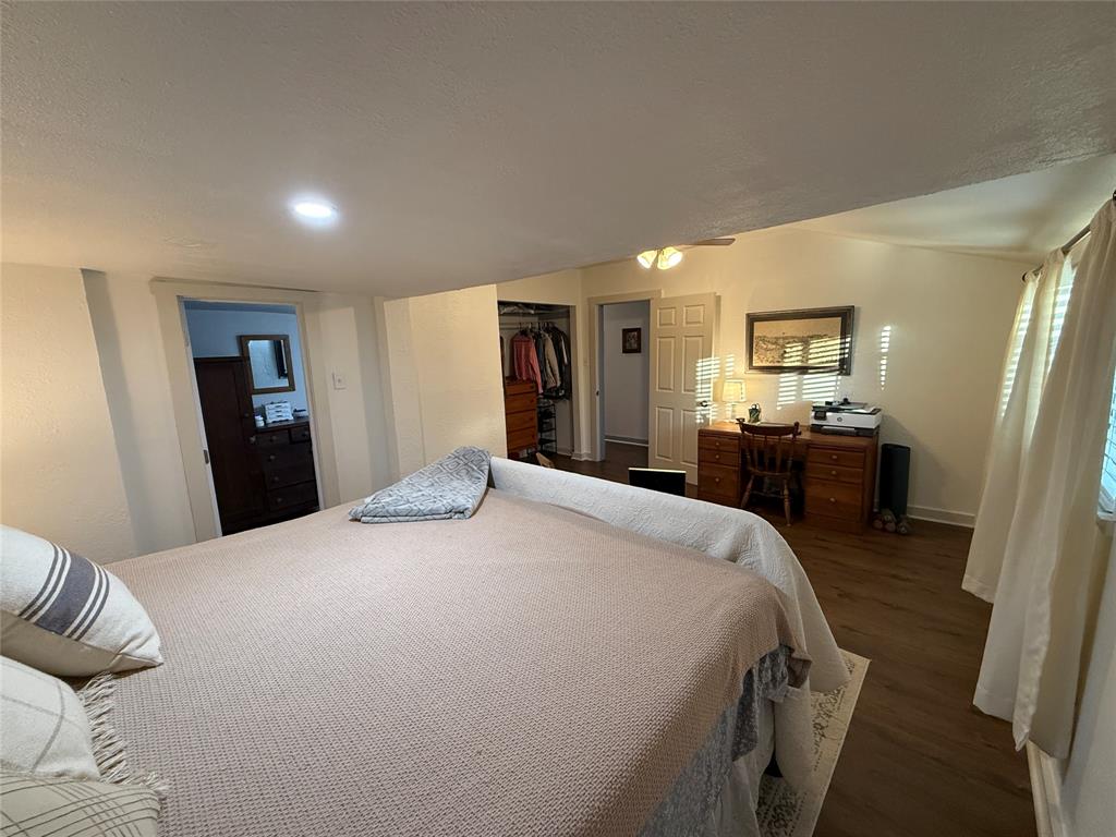 407 South Reagan Street Hamilton, TX 76531 - Photo 23 of 39 a bed room with a bed and a television