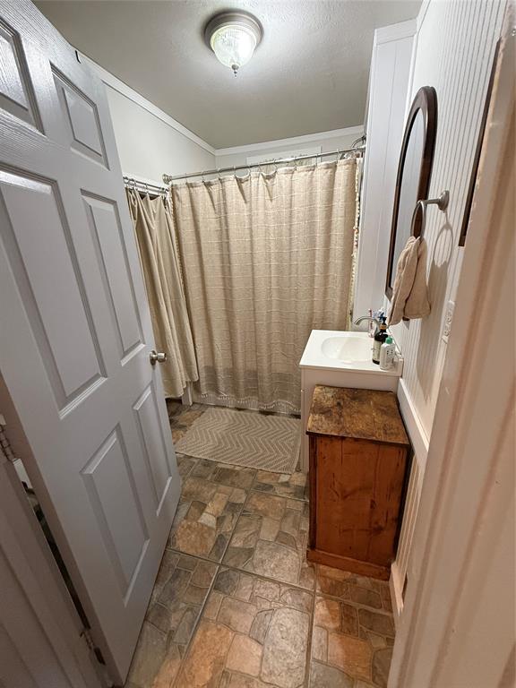 407 South Reagan Street Hamilton, TX 76531 - Photo 31 of 39 a bathroom with a sink a washer and dryer