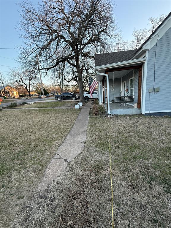 407 South Reagan Street Hamilton, TX 76531 - Photo 32 of 39 a view of a house with a yard