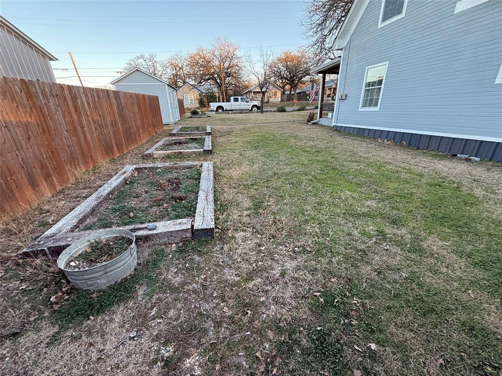 407 South Reagan Street Hamilton, TX 76531 - Photo 34 of 39 a view of a backyard with wooden fence