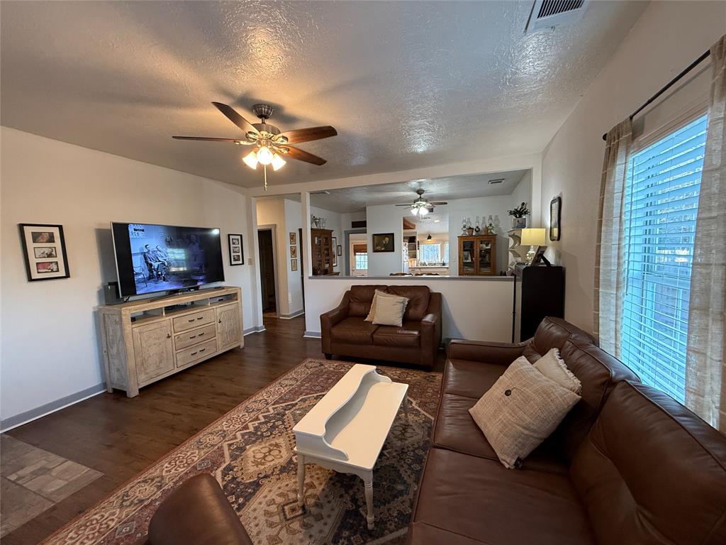 407 South Reagan Street Hamilton, TX 76531 - Photo 9 of 39 a living room with furniture and a flat screen tv