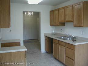 794 Castle Valley Boulevard, Unit H New Castle, CO 81647 - Photo 2 of 8 a kitchen with a sink and cabinets