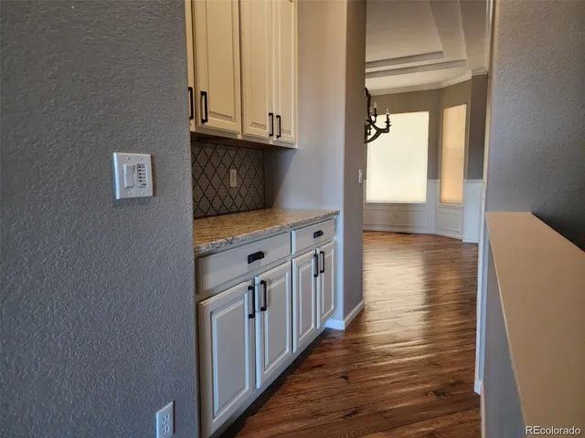 a kitchen with wooden floor and a window