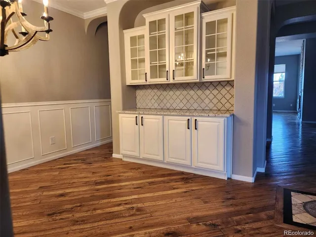 a view of a livingroom with wooden floor and staircase